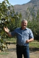 L’image montre un maraîcher arménien à côté d’un de ses arbres fruitiers.