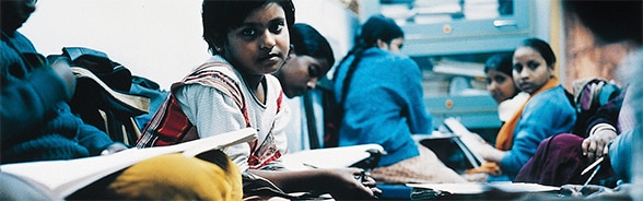 Young girls reading documents in an organisation for women’s education in Calcutta